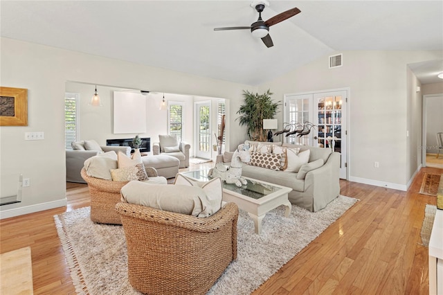 6402 23rd Avenue Dr W, Bradenton, FL 34209 - living room featuring a ceiling fan, light wood-type flooring, healthy amount of natural light, lofted ceiling, and baseboards