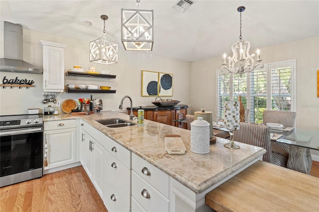 6402 23rd Avenue Dr W, Bradenton, FL 34209 - kitchen featuring wall chimney range hood, a chandelier, stainless steel electric stove, and a peninsula