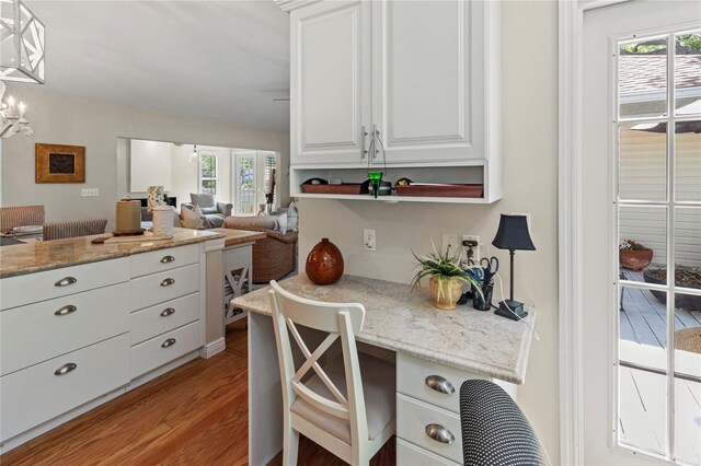 6402 23rd Avenue Dr W, Bradenton, FL 34209 - kitchen with healthy amount of natural light, light wood-style flooring, open floor plan, and white cabinetry