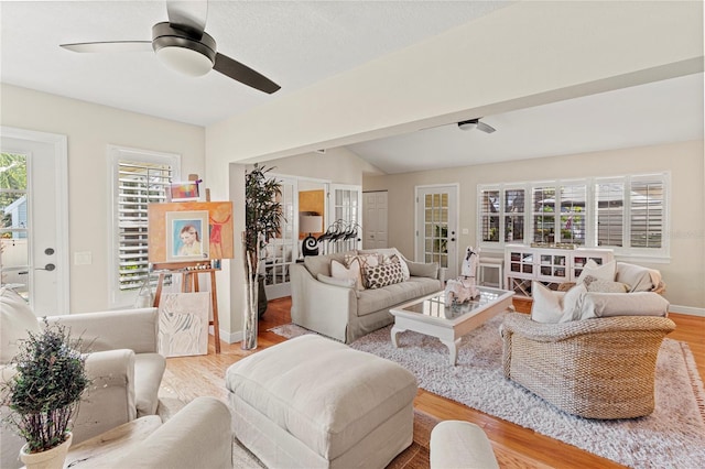 6402 23rd Avenue Dr W, Bradenton, FL 34209 - living area featuring a ceiling fan, light wood-style floors, baseboards, french doors, and vaulted ceiling