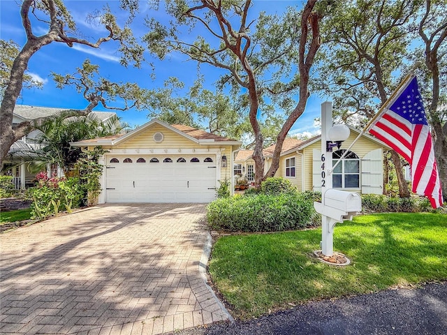 6402 23rd Avenue Dr W, Bradenton, FL 34209 - view of front facade with a front yard, decorative driveway, and an attached garage