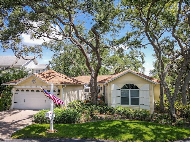 6402 23rd Avenue Dr W, Bradenton, FL 34209 - view of front of house featuring an attached garage, concrete driveway, and a front yard