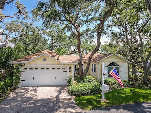 6402 23rd Avenue Dr W, Bradenton, FL 34209 - single story home featuring decorative driveway, an attached garage, and a front yard