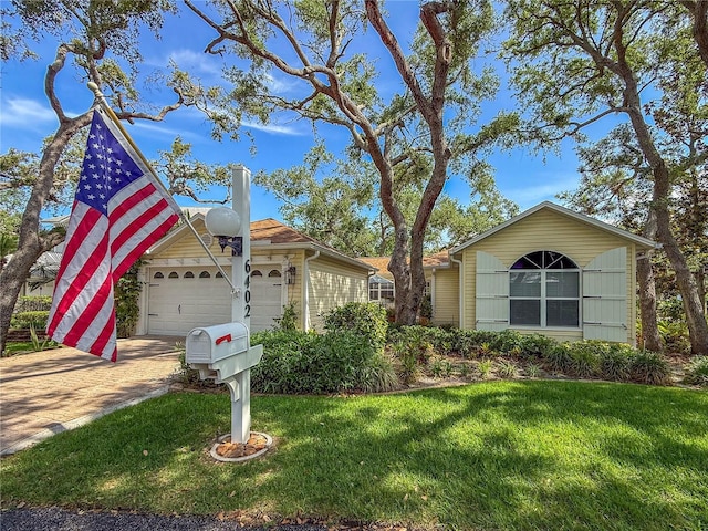 6402 23rd Avenue Dr W, Bradenton, FL 34209 - ranch-style home with a front lawn, an attached garage, and driveway