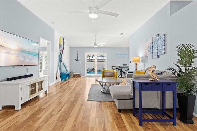 living room featuring ceiling fan and light wood-style flooring