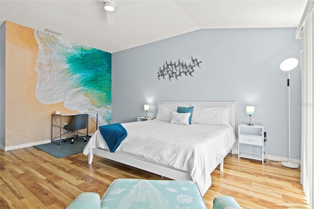bedroom with lofted ceiling, wood finished floors, and baseboards