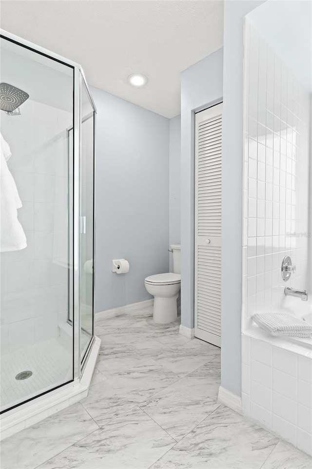 bathroom with baseboards, a shower stall, marble finish flooring, and toilet