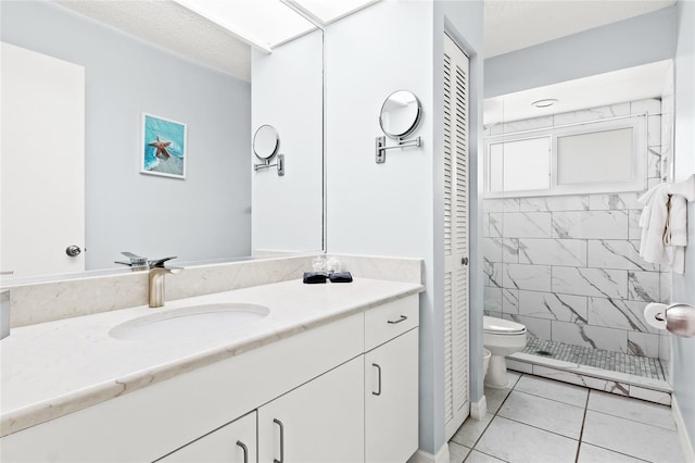 full bath featuring a closet, baseboard heating, toilet, tile patterned flooring, and vanity