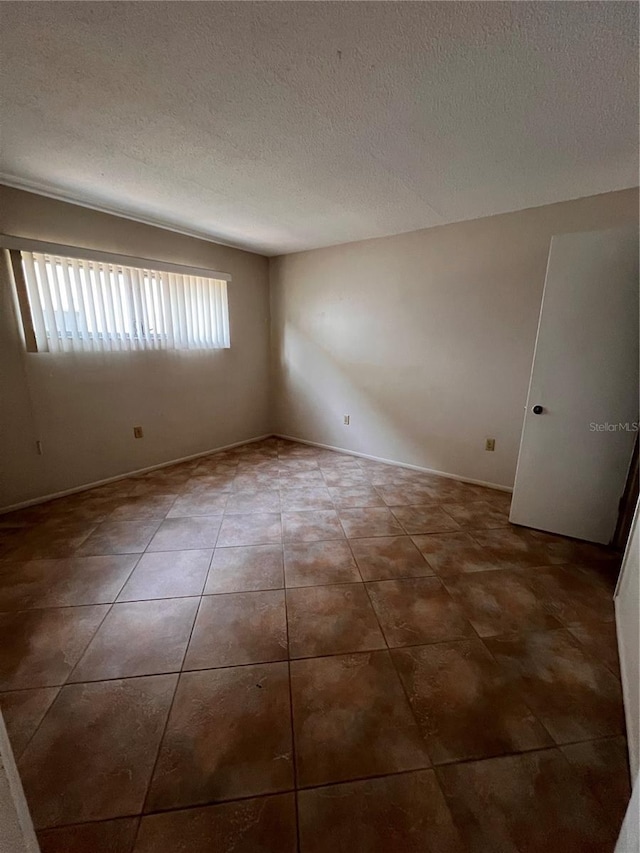 4035 S School Ave Unit D3, Sarasota, FL 34231 - tiled spare room with a textured ceiling