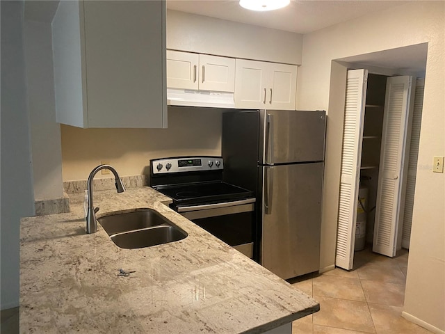 4035 S School Ave Unit D3, Sarasota, FL 34231 - kitchen with appliances with stainless steel finishes, a sink, under cabinet range hood, light stone countertops, and white cabinetry