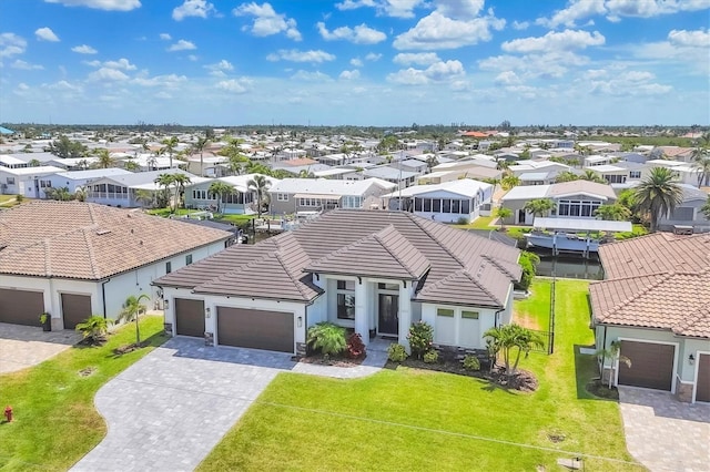4312 Vasco St, Punta Gorda, FL 33950 - view of front of house featuring a tile roof, an attached garage, a residential view, stucco siding, and decorative driveway