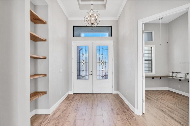 4312 Vasco St, Punta Gorda, FL 33950 - entryway featuring a chandelier, wood finished floors, french doors, ornamental molding, and baseboards