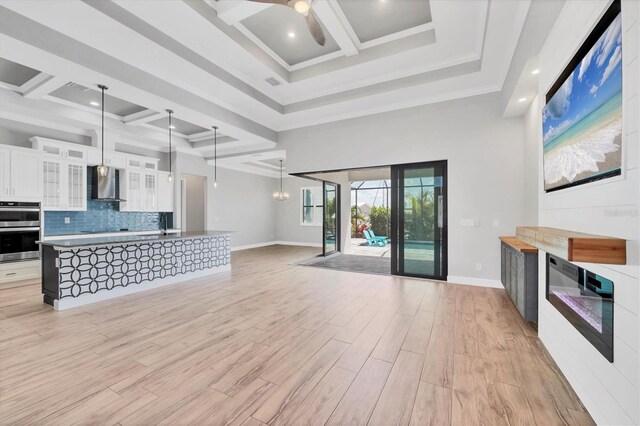 4312 Vasco St, Punta Gorda, FL 33950 - unfurnished living room with coffered ceiling, a ceiling fan, light wood finished floors, beamed ceiling, and baseboards