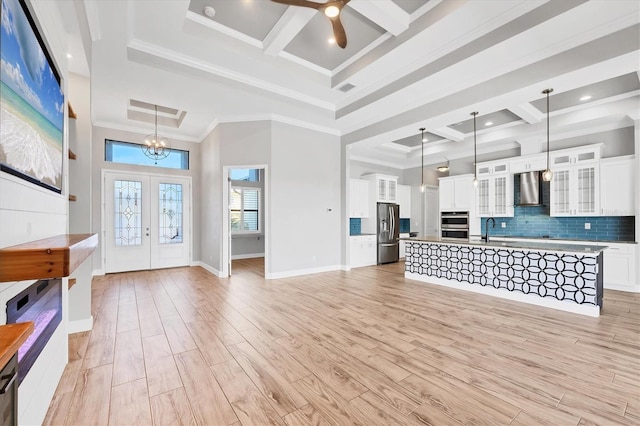 4312 Vasco St, Punta Gorda, FL 33950 - unfurnished living room with coffered ceiling, ceiling fan, a high ceiling, a chandelier, and beamed ceiling