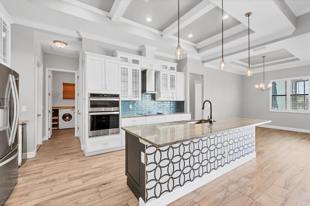 4312 Vasco St, Punta Gorda, FL 33950 - kitchen with a sink, washer / dryer, appliances with stainless steel finishes, wall chimney exhaust hood, and light stone counters