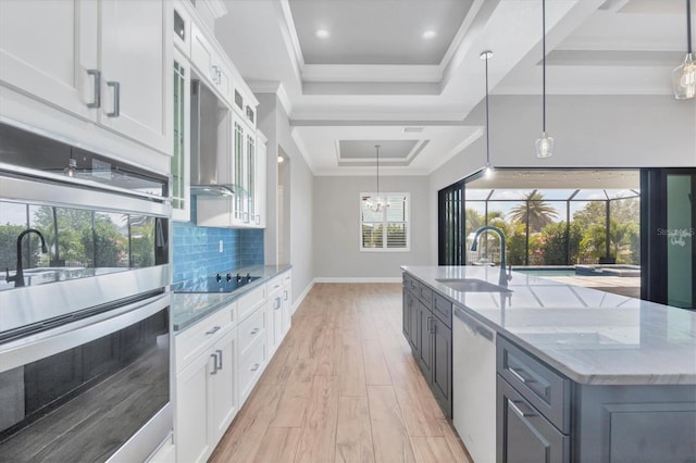 4312 Vasco St, Punta Gorda, FL 33950 - kitchen with a raised ceiling, appliances with stainless steel finishes, a sink, white cabinets, and light stone counters