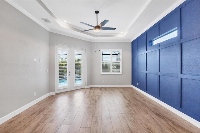 4312 Vasco St, Punta Gorda, FL 33950 - empty room with a raised ceiling, ceiling fan, light wood-type flooring, crown molding, and baseboards