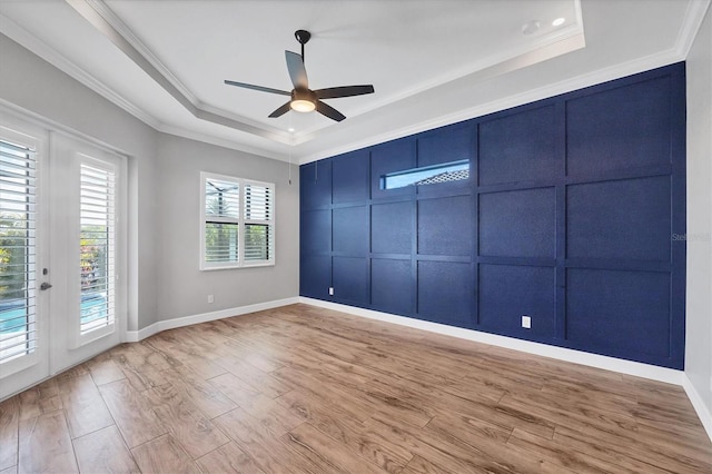 4312 Vasco St, Punta Gorda, FL 33950 - spare room with a raised ceiling, crown molding, ceiling fan, wood finished floors, and a decorative wall