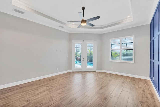 4312 Vasco St, Punta Gorda, FL 33950 - spare room with a tray ceiling, ceiling fan, light wood-type flooring, french doors, and crown molding
