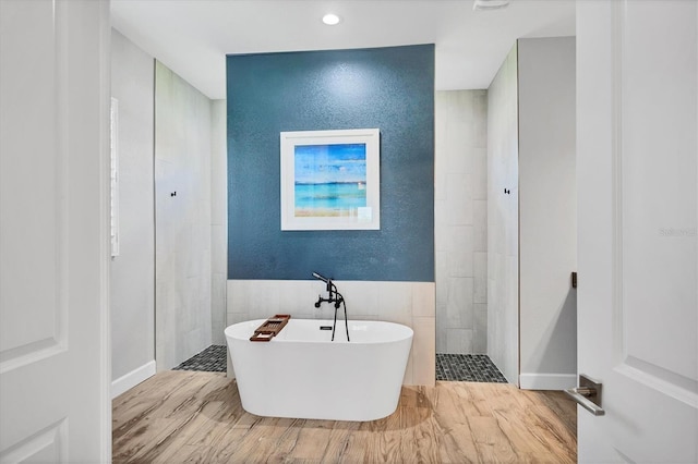 4312 Vasco St, Punta Gorda, FL 33950 - full bathroom with a freestanding tub, tile walls, walk in shower, wood finished floors, and recessed lighting