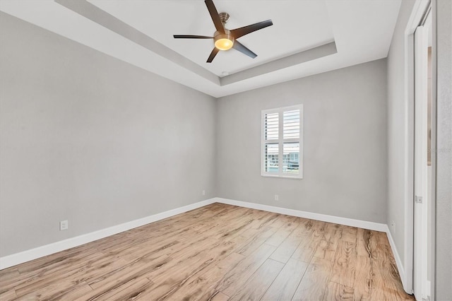4312 Vasco St, Punta Gorda, FL 33950 - unfurnished room featuring a tray ceiling, light wood-style floors, baseboards, and ceiling fan