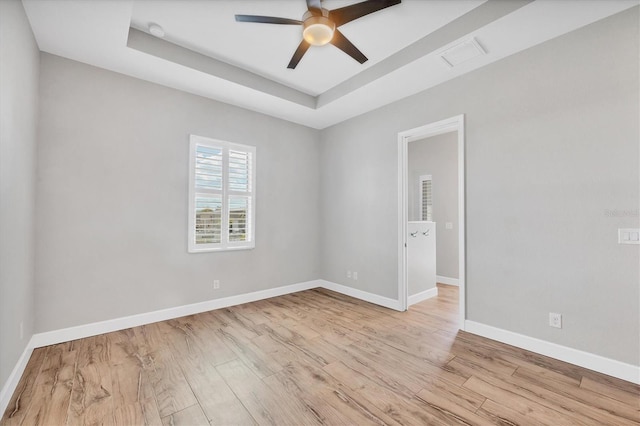 4312 Vasco St, Punta Gorda, FL 33950 - unfurnished room with light wood-type flooring, a ceiling fan, a raised ceiling, and baseboards