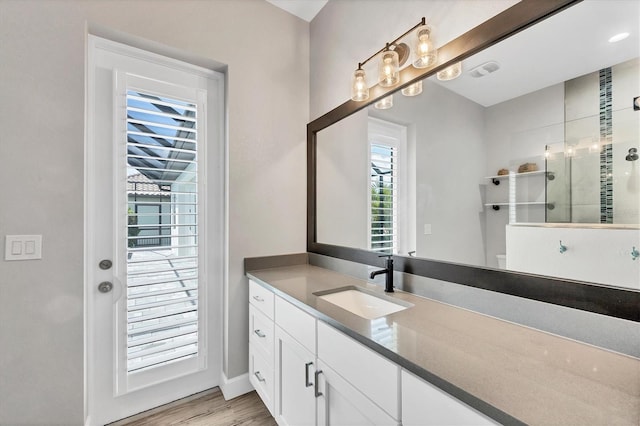 4312 Vasco St, Punta Gorda, FL 33950 - full bath with a walk in shower, vanity, wood finished floors, and baseboards
