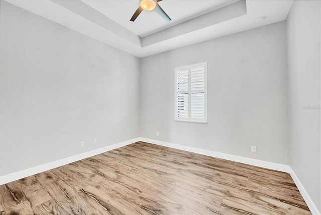 4312 Vasco St, Punta Gorda, FL 33950 - empty room featuring baseboards, wood finished floors, a tray ceiling, and ceiling fan