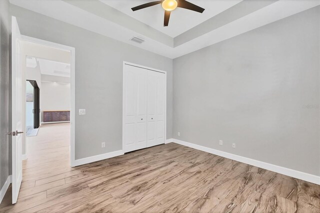 4312 Vasco St, Punta Gorda, FL 33950 - unfurnished bedroom with wood finished floors, baseboards, a closet, and a ceiling fan