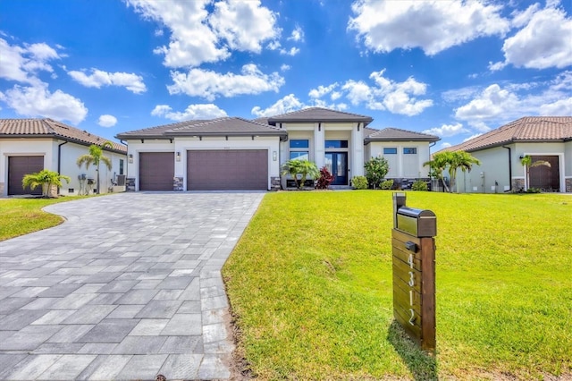4312 Vasco St, Punta Gorda, FL 33950 - view of front of house featuring decorative driveway, a garage, a front lawn, stucco siding, and a tiled roof
