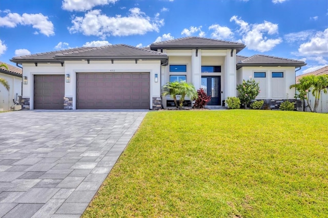 4312 Vasco St, Punta Gorda, FL 33950 - prairie-style house with an attached garage, a front lawn, french doors, and a tiled roof
