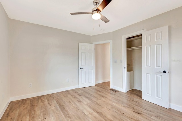unfurnished bedroom with light wood-type flooring, baseboards, a closet, and a ceiling fan