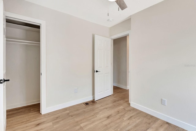 unfurnished bedroom with light wood-style flooring and baseboards