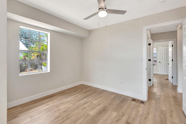 empty room with baseboards, light wood-style flooring, and ceiling fan