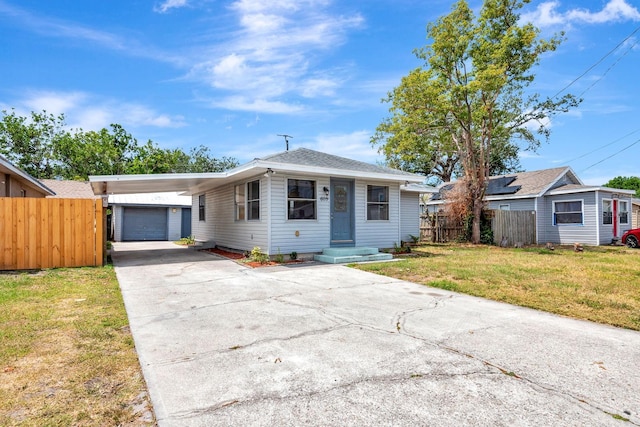 bungalow-style home featuring driveway, a garage, and a carport