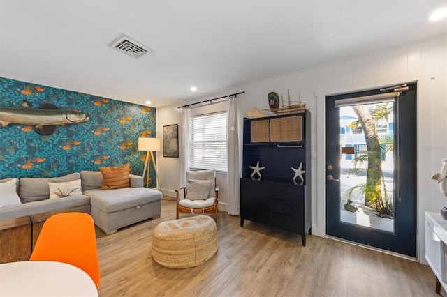 205 71st St Unit B, Holmes Beach, FL 34217 - living area with an accent wall, light wood-type flooring, wallpapered walls, recessed lighting, and baseboards