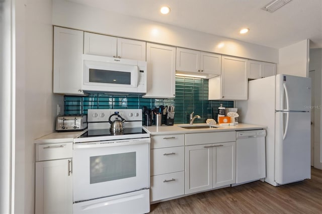 205 71st St Unit B, Holmes Beach, FL 34217 - kitchen with white appliances, a sink, light countertops, white cabinets, and decorative backsplash