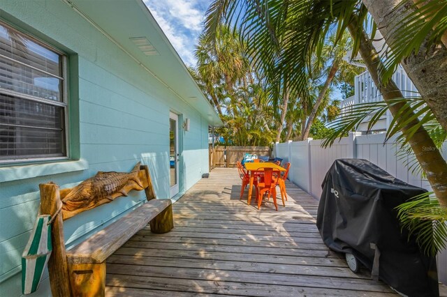 205 71st St Unit B, Holmes Beach, FL 34217 - wooden deck featuring a fenced backyard, outdoor dining space, and a grill