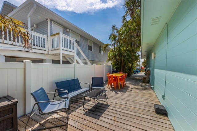 205 71st St Unit B, Holmes Beach, FL 34217 - deck with outdoor dining space, fence, and an outdoor hangout area