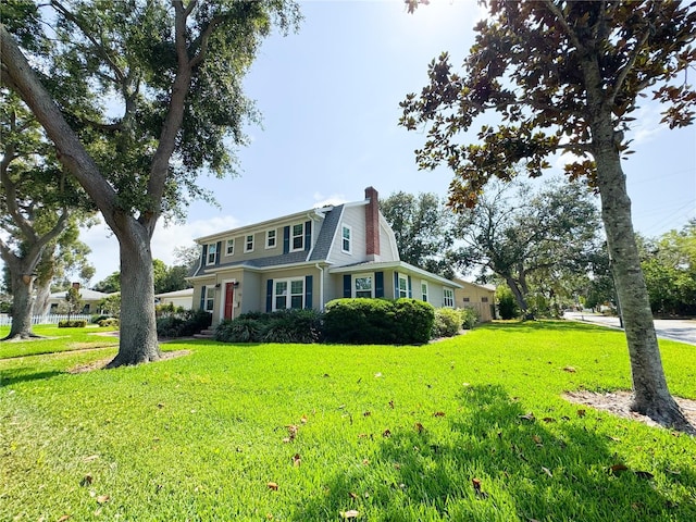 view of front of property with a chimney and a front yard