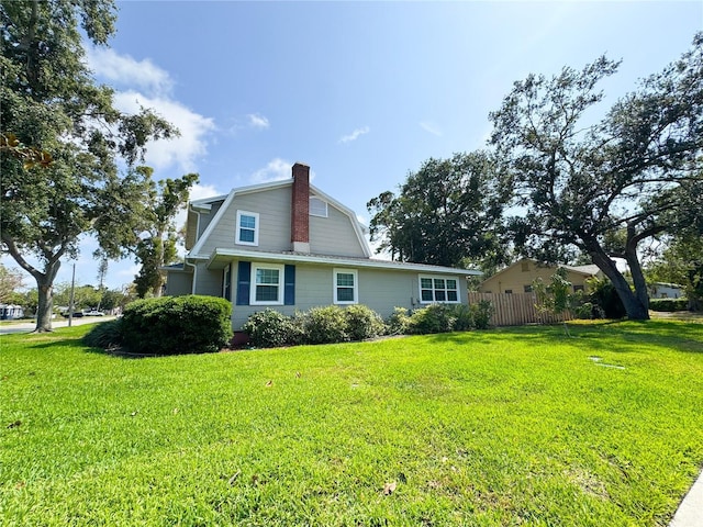 view of property exterior featuring a gambrel roof and a chimney