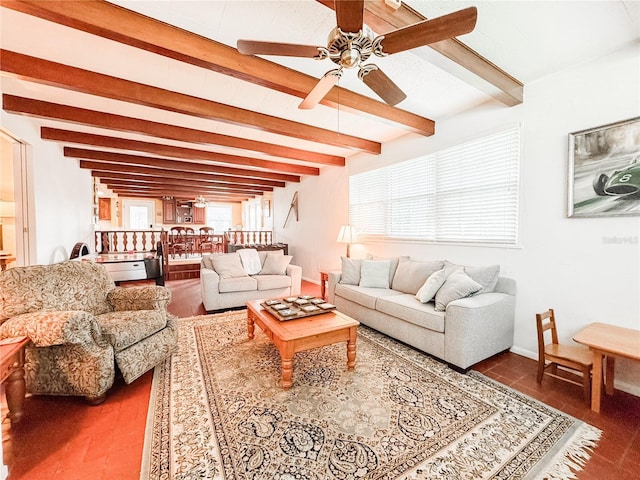 living area featuring ceiling fan, beamed ceiling, and baseboards