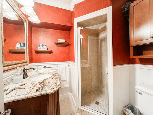 full bath featuring crown molding, a stall shower, wainscoting, vanity, and toilet