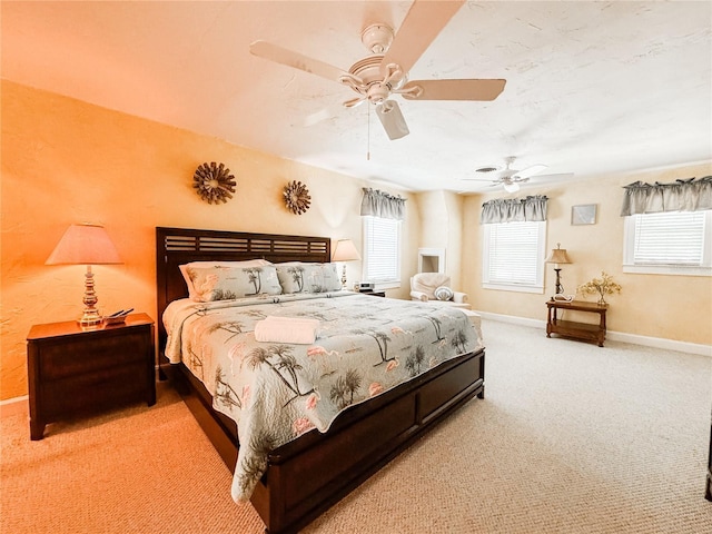 carpeted bedroom featuring baseboards and ceiling fan