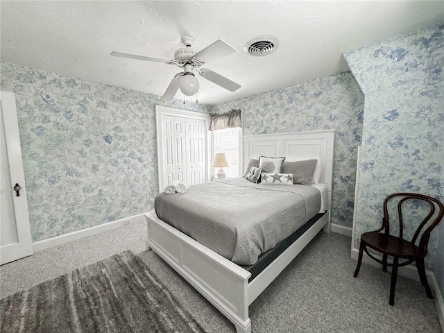 carpeted bedroom featuring wallpapered walls, baseboards, ceiling fan, and a closet