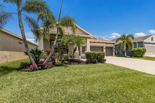 11513 11th Ave E, Bradenton, FL 34212 - view of front facade with an attached garage, driveway, stucco siding, and a front yard