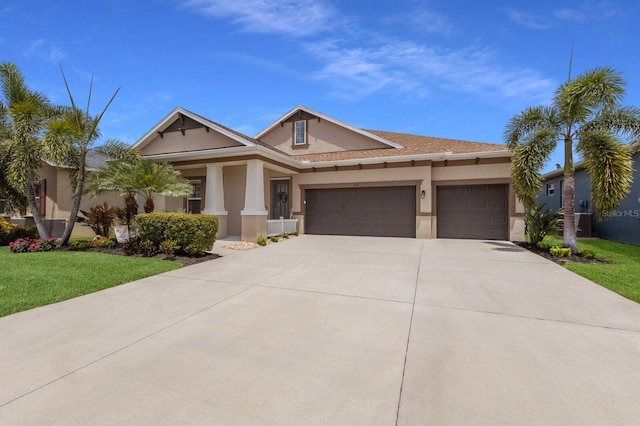 11513 11th Ave E, Bradenton, FL 34212 - view of front of home with stucco siding, an attached garage, concrete driveway, and a front yard