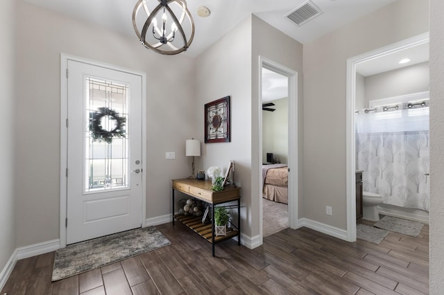 11513 11th Ave E, Bradenton, FL 34212 - foyer entrance with a chandelier, dark wood finished floors, and baseboards