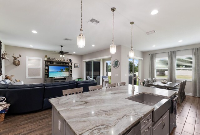 11513 11th Ave E, Bradenton, FL 34212 - kitchen featuring recessed lighting, open floor plan, pendant lighting, light stone countertops, and a sink