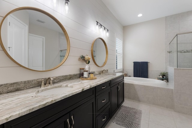 11513 11th Ave E, Bradenton, FL 34212 - bathroom featuring tiled shower, a bath, tile patterned floors, and double vanity